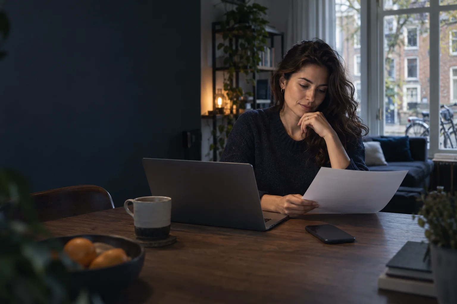 Illustrative expat reviewing a new employment offer at home in the Netherlands